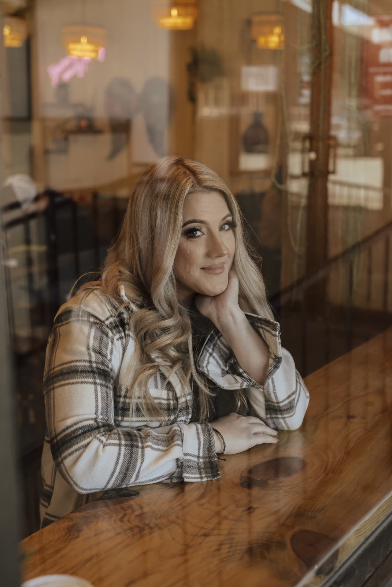 Candace Roberts seated by a cafe window